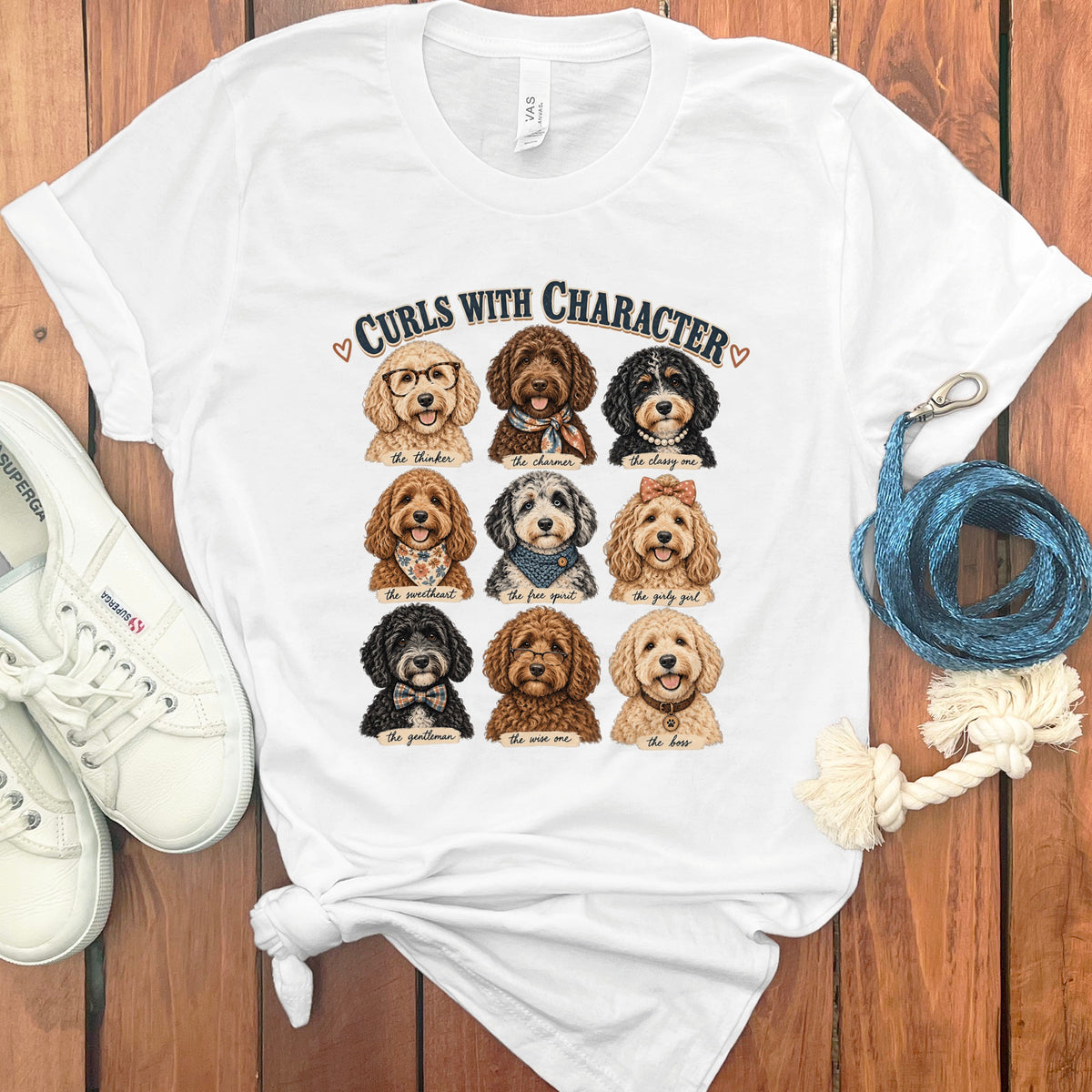 White t-shirt featuring nine cartoon dogs with captions and "Curls with Character" text.