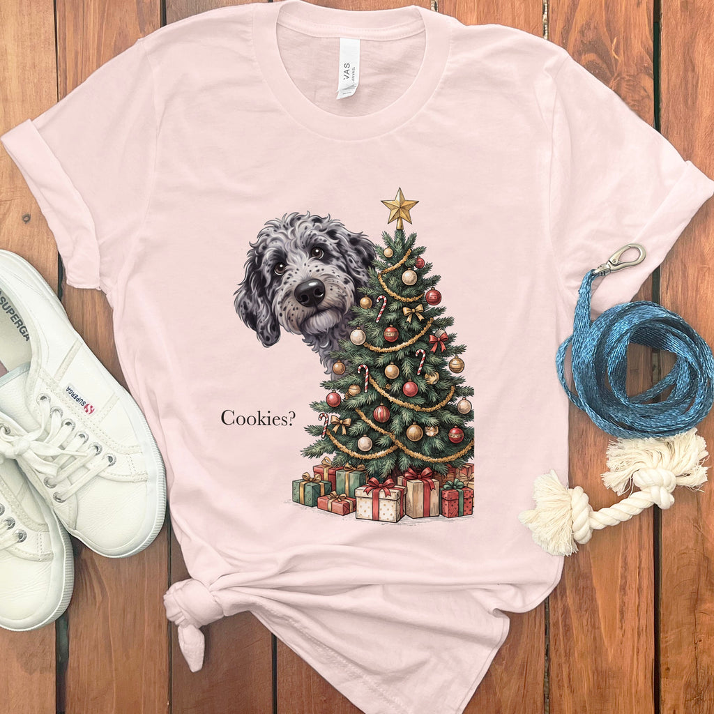 T-shirt with a dog peeking from behind a decorated Christmas tree and the text "Cookies?"