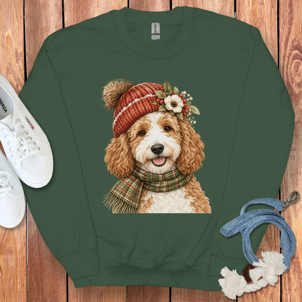 Green crewneck sweatshirt with a watercolor print of a golden doodle wearing a winter hat and scarf.