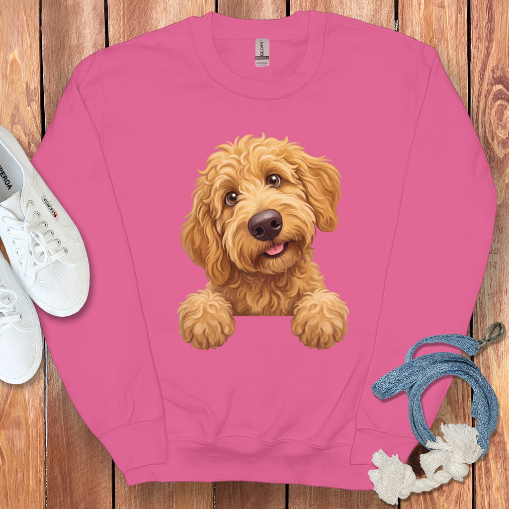 Pink sweatshirt with a drawing of a goldendoodle puppy peeking over the collar.