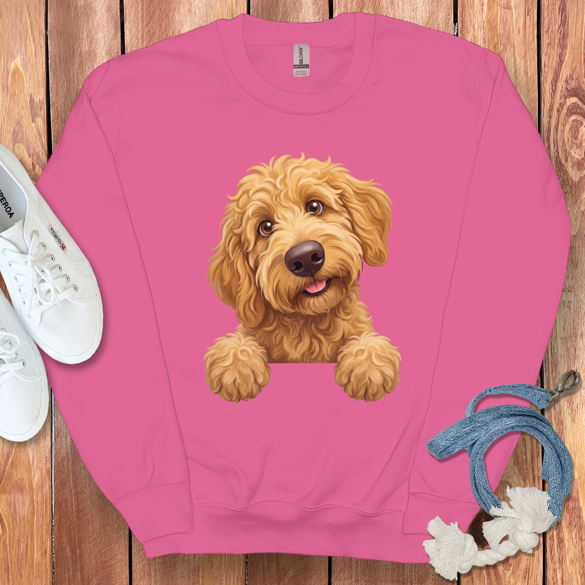 Pink sweatshirt with a drawing of a goldendoodle puppy peeking over the collar.