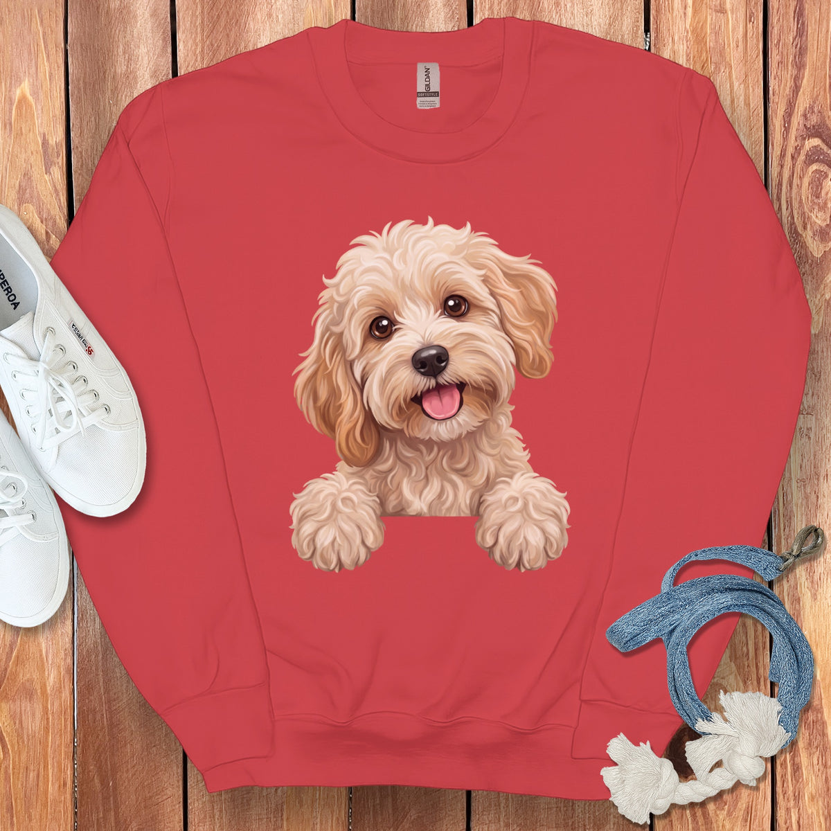 Coral sweatshirt with a cartoon dog graphic and white sneakers.