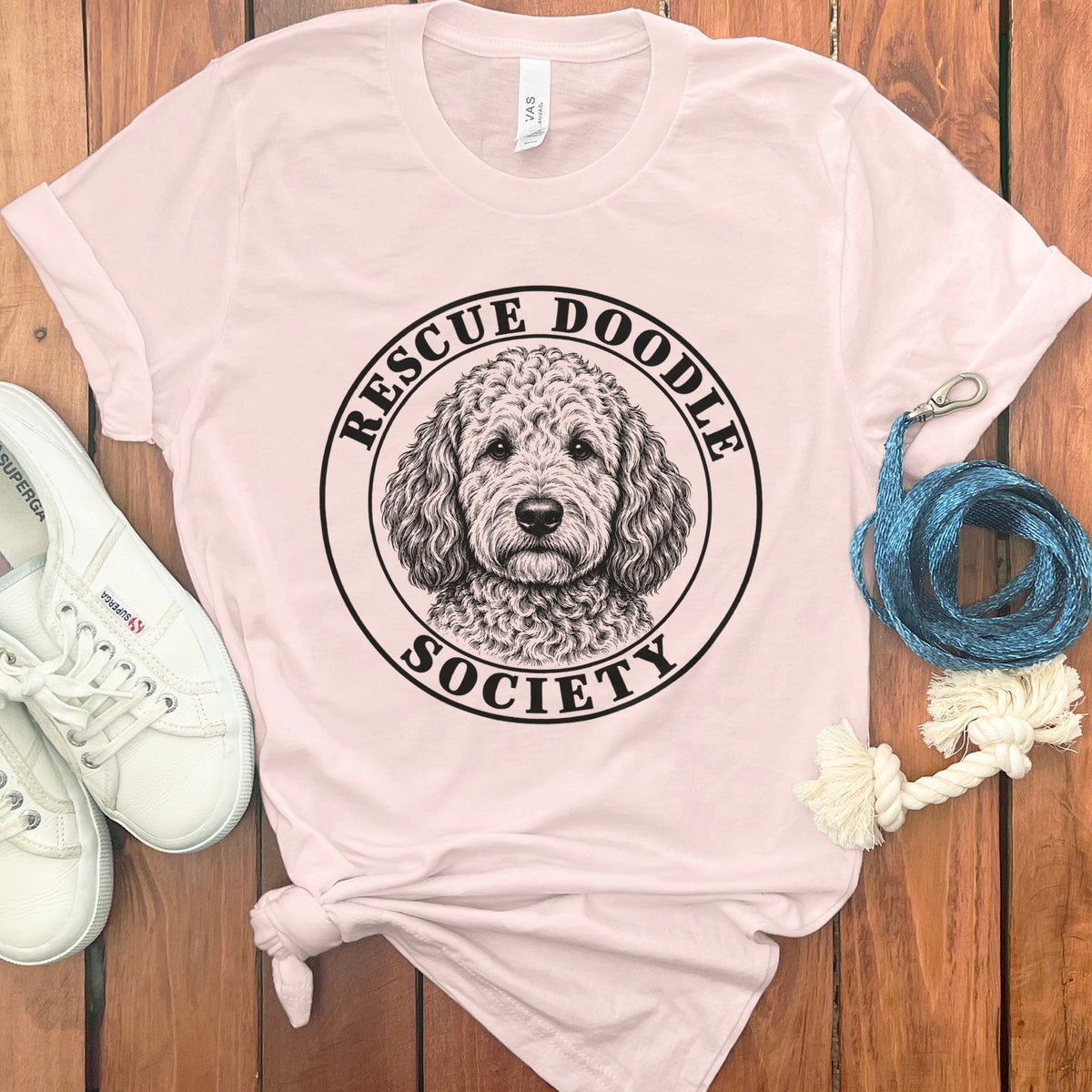 Pink t-shirt with black line drawing of a doodle dog and text "RESCUE DOODLE SOCIETY".