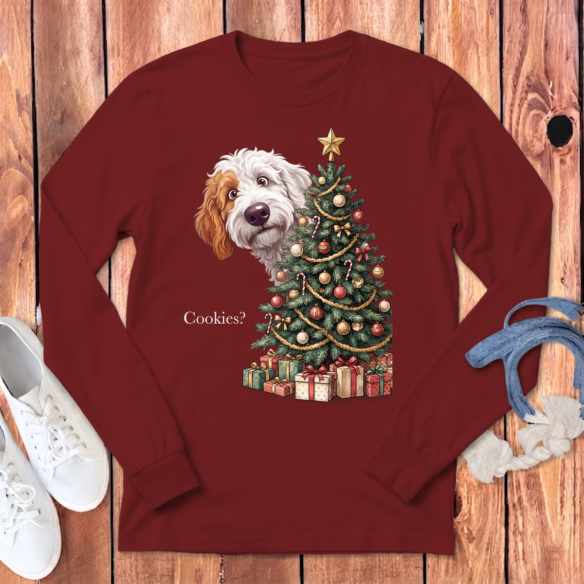 Maroon long sleeve shirt with a dog peeking from behind a Christmas tree and the text "Cookies?".