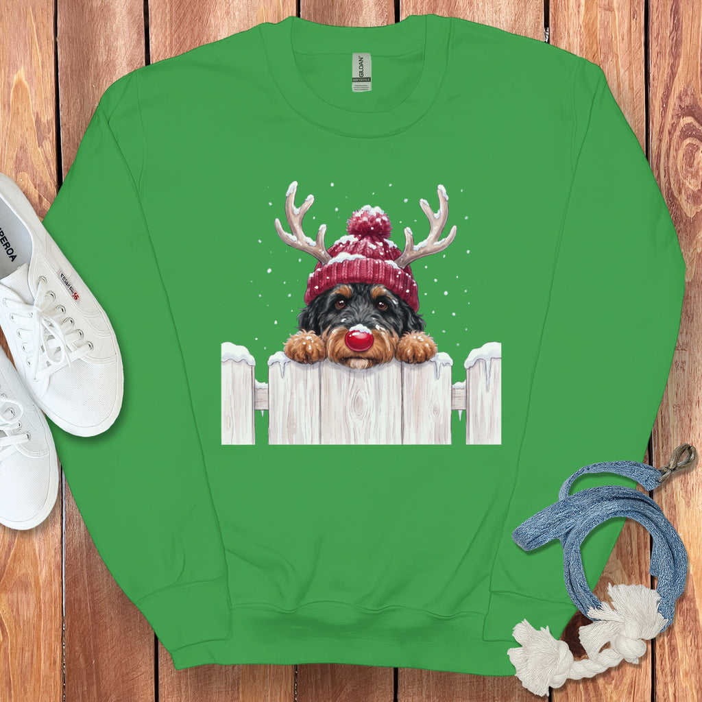 Green sweatshirt with a doodle of a dog wearing a Santa hat and reindeer antlers.