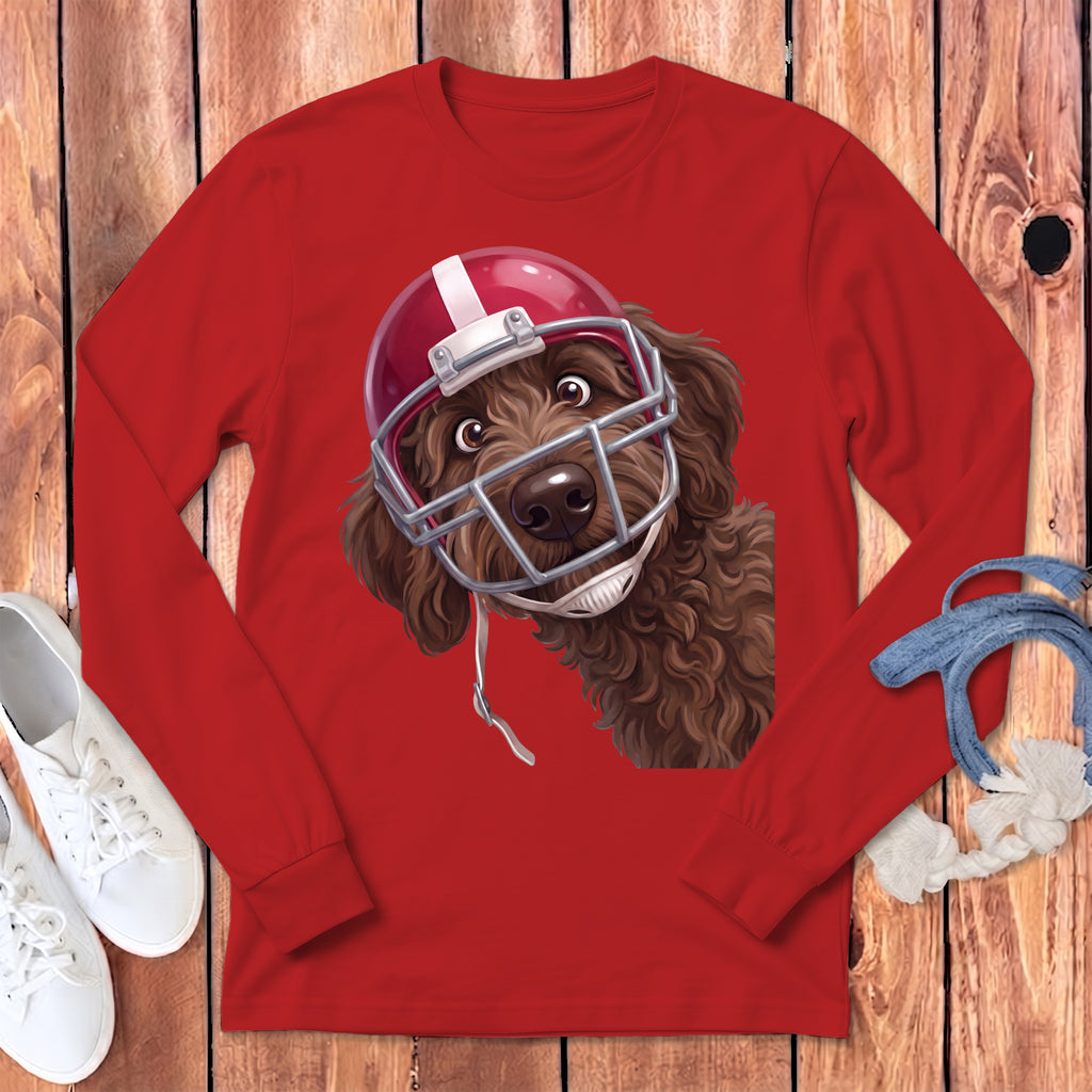 Brown dog wearing a red and white football helmet on a red long-sleeved shirt.