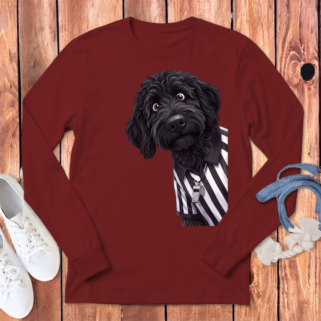 Black poodle wearing a referee shirt and whistle on a maroon long-sleeve shirt.