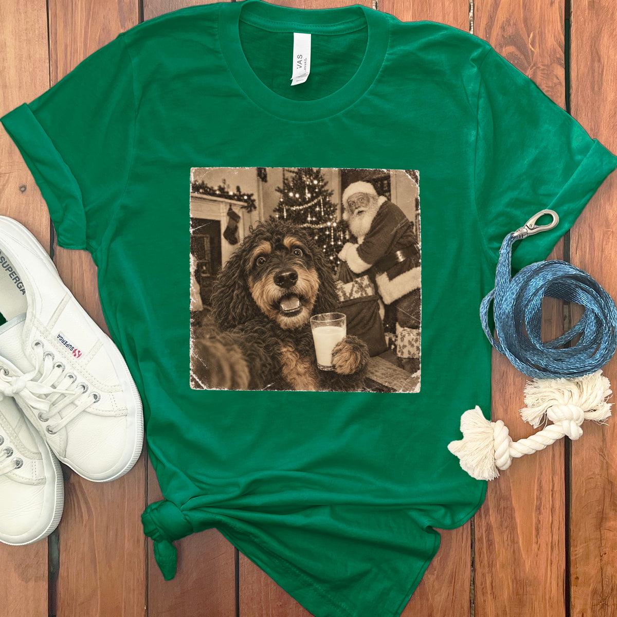 Kelly green crewneck t-shirt featuring a black and white graphic of a dog holding a glass of milk with Santa Claus in the background.