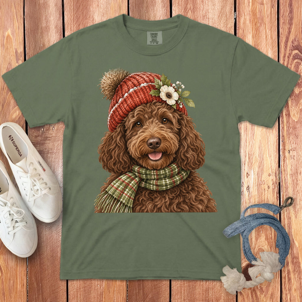 Green t-shirt with a watercolor print of a brown dog wearing a hat and scarf.