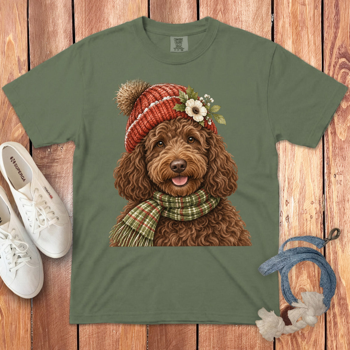 Green t-shirt with a watercolor print of a brown dog wearing a hat and scarf.