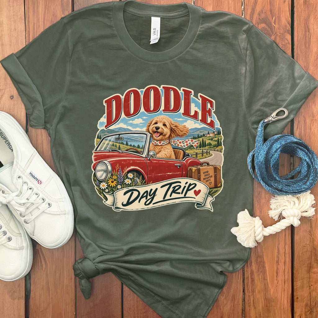 T-shirt graphic of a doodle dog in a convertible with "Doodle Day Trip" text.