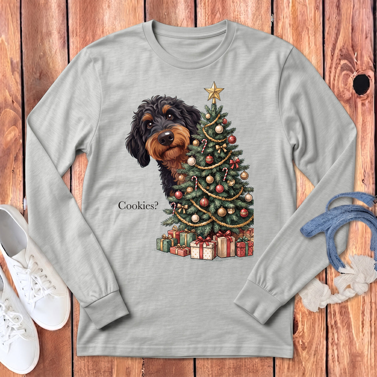 Dachshund peeking from behind a decorated Christmas tree with presents and text "Cookies?".