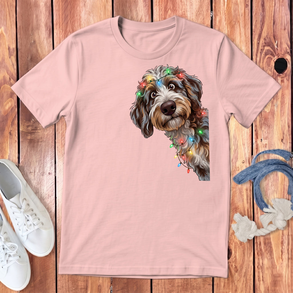 Pink t-shirt with a doodle dog wearing festive lights.