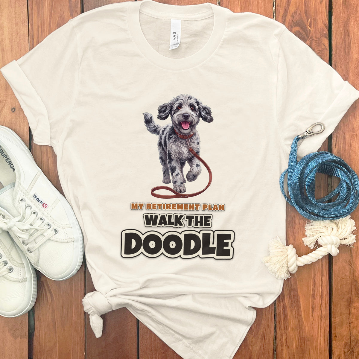 Cream t-shirt with graphic of dog and text "My Retirement Plan Walk the Doodle".