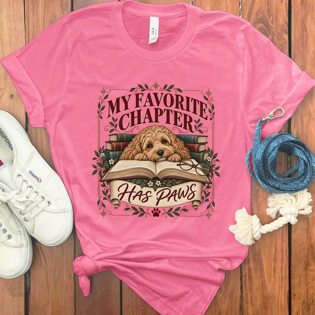 Pink t-shirt with graphic: dog on open book, "My Favorite Chapter Has Paws".
