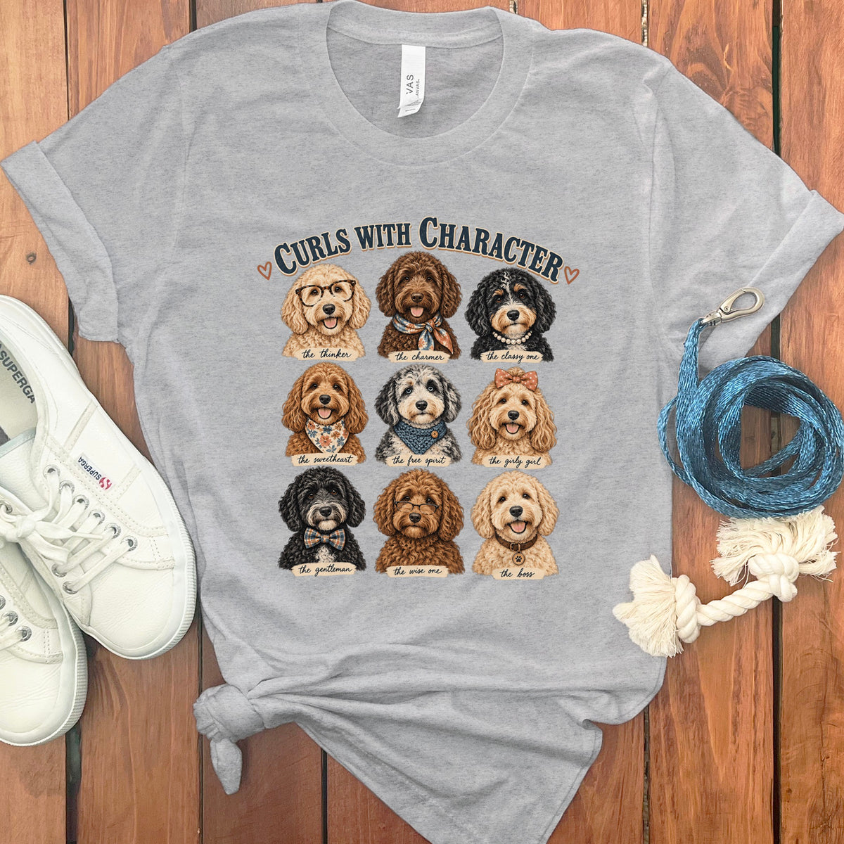 Grey t-shirt with "Curls with Character" text and nine illustrated doodle dogs.