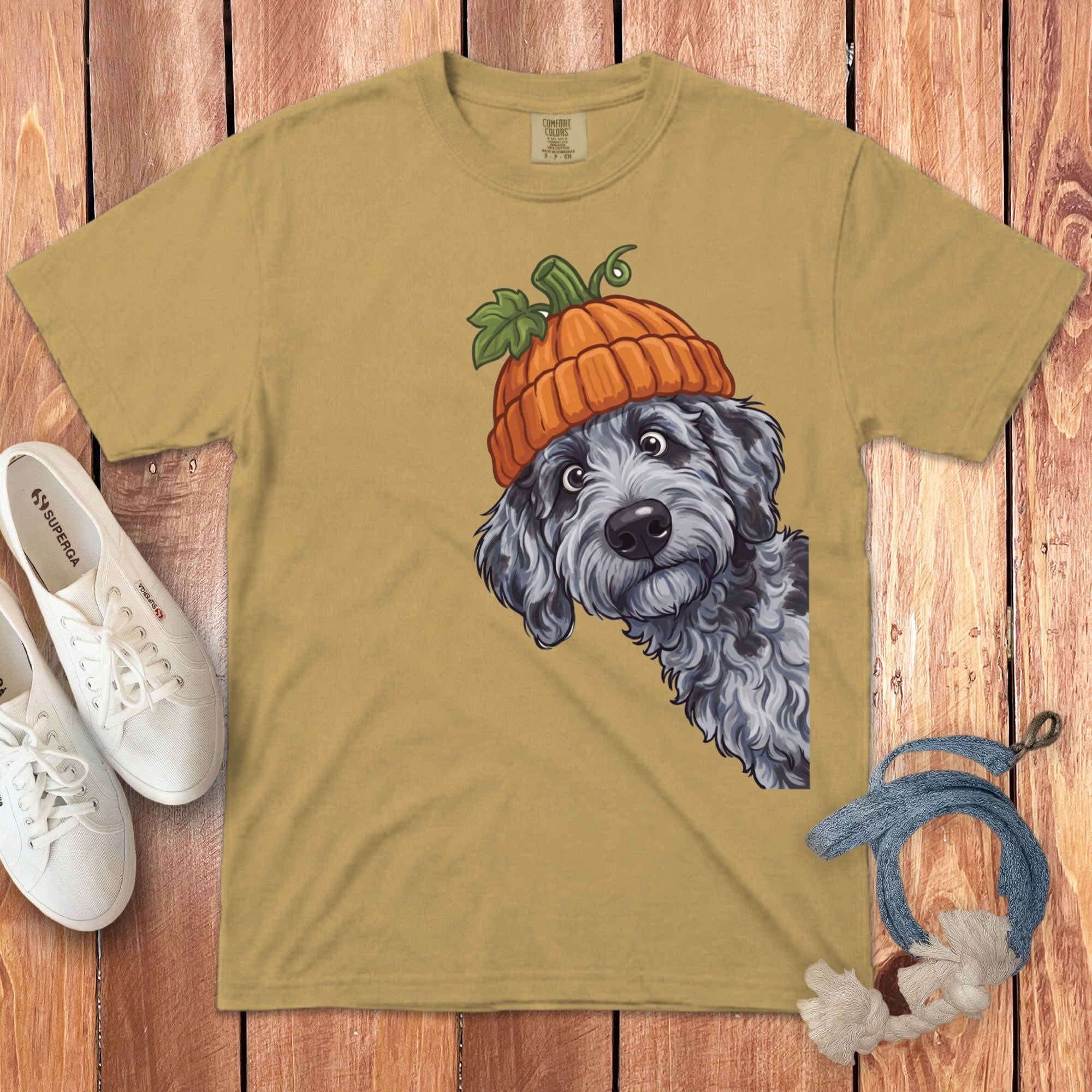 Tan t-shirt with playful dog wearing a pumpkin hat illustration.