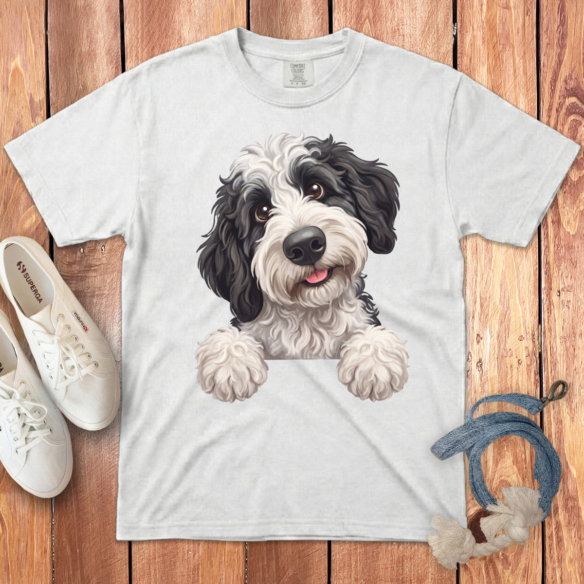 White t-shirt with a black and white doodle dog illustration wearing a white shirt.