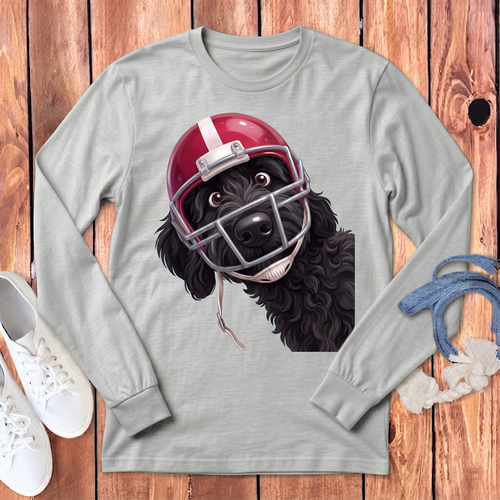 Black dog wearing a red and white football helmet on a gray long-sleeve shirt.