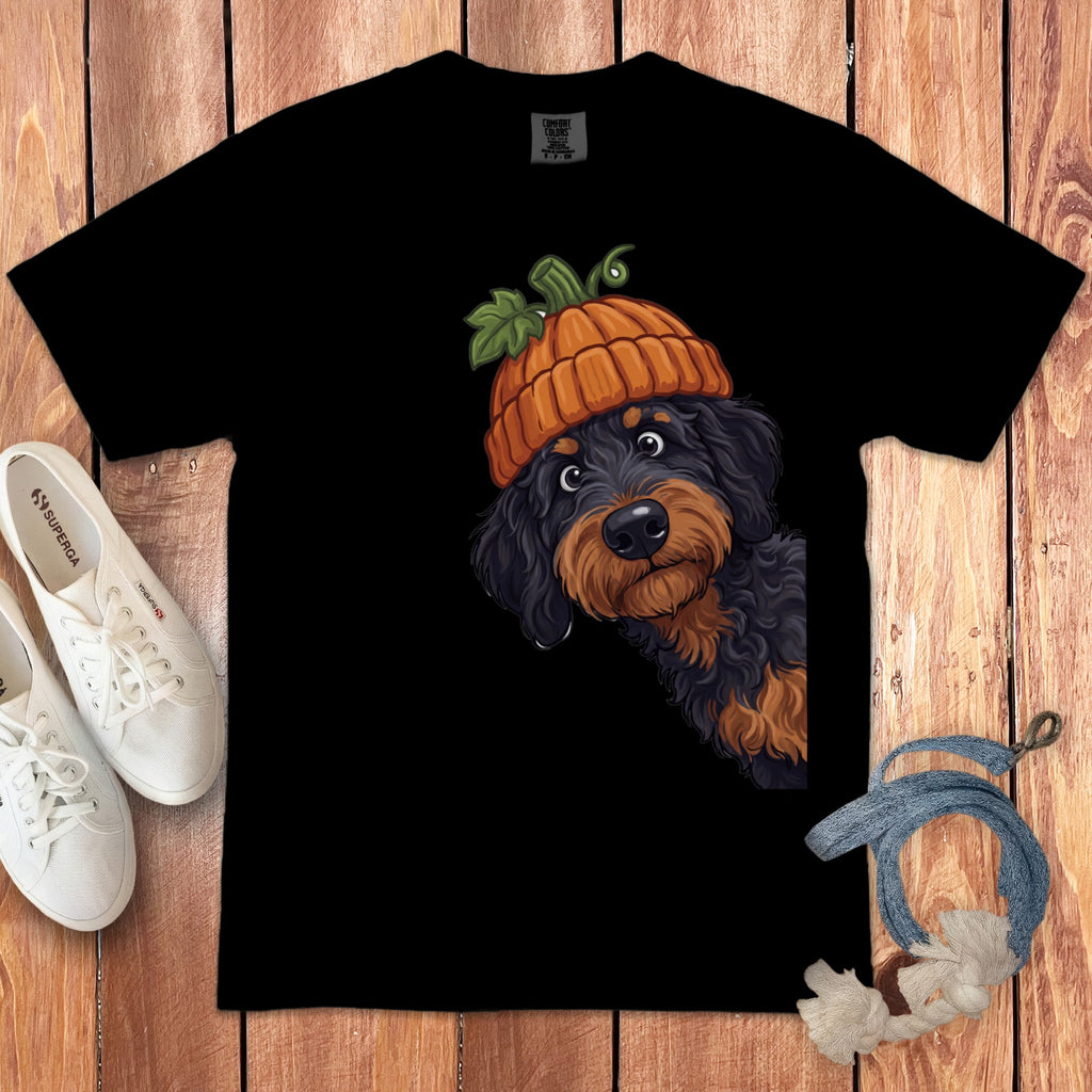 Black t-shirt with a black dog wearing a pumpkin hat on the chest.