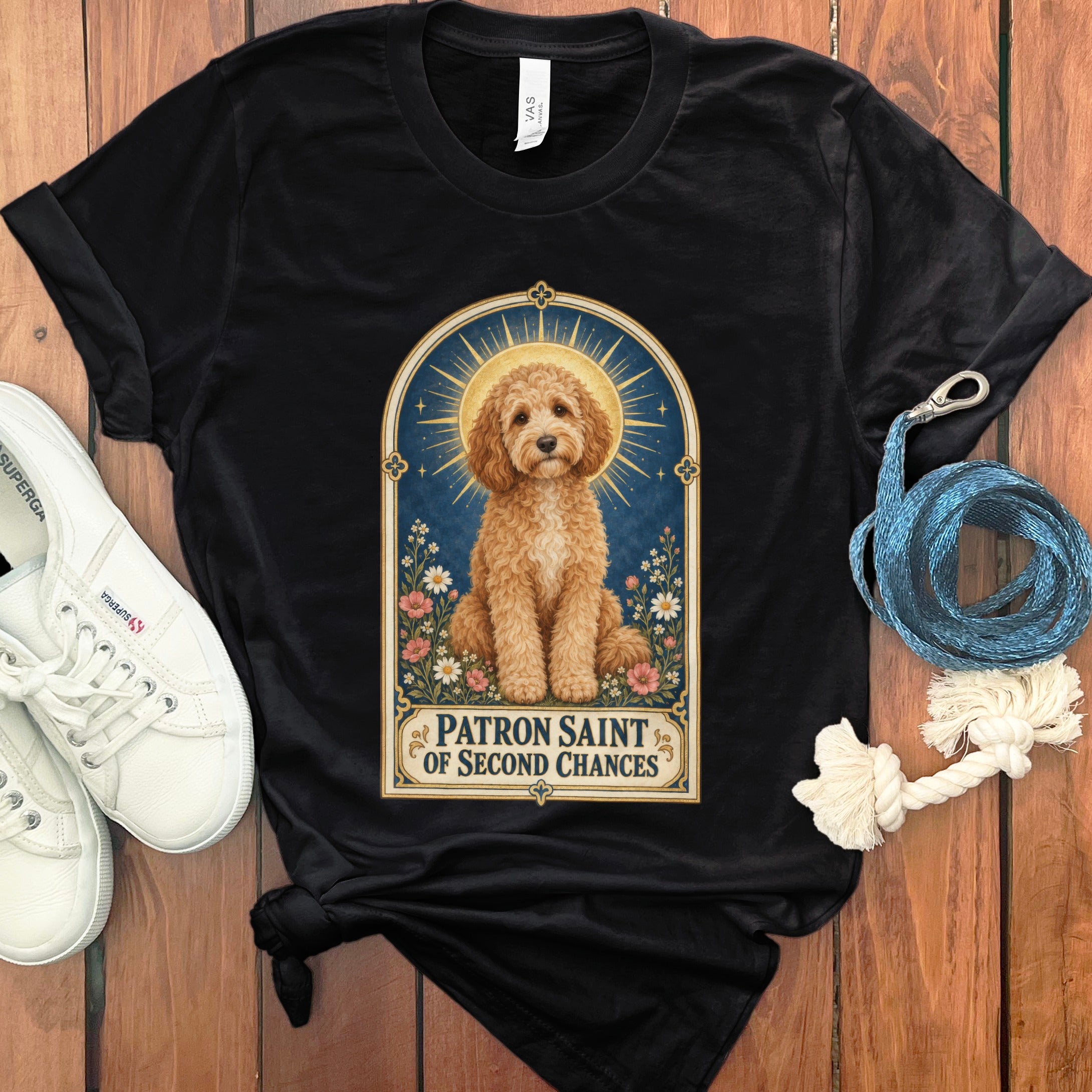 Black t-shirt with a golden doodle illustration and text "Patron Saint of Second Chances".