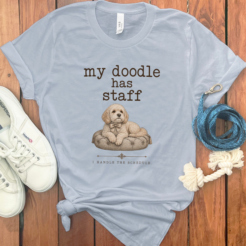 Light blue t-shirt with "my doodle has staff I HANDLE THE SCHEDULE" and dog illustration.