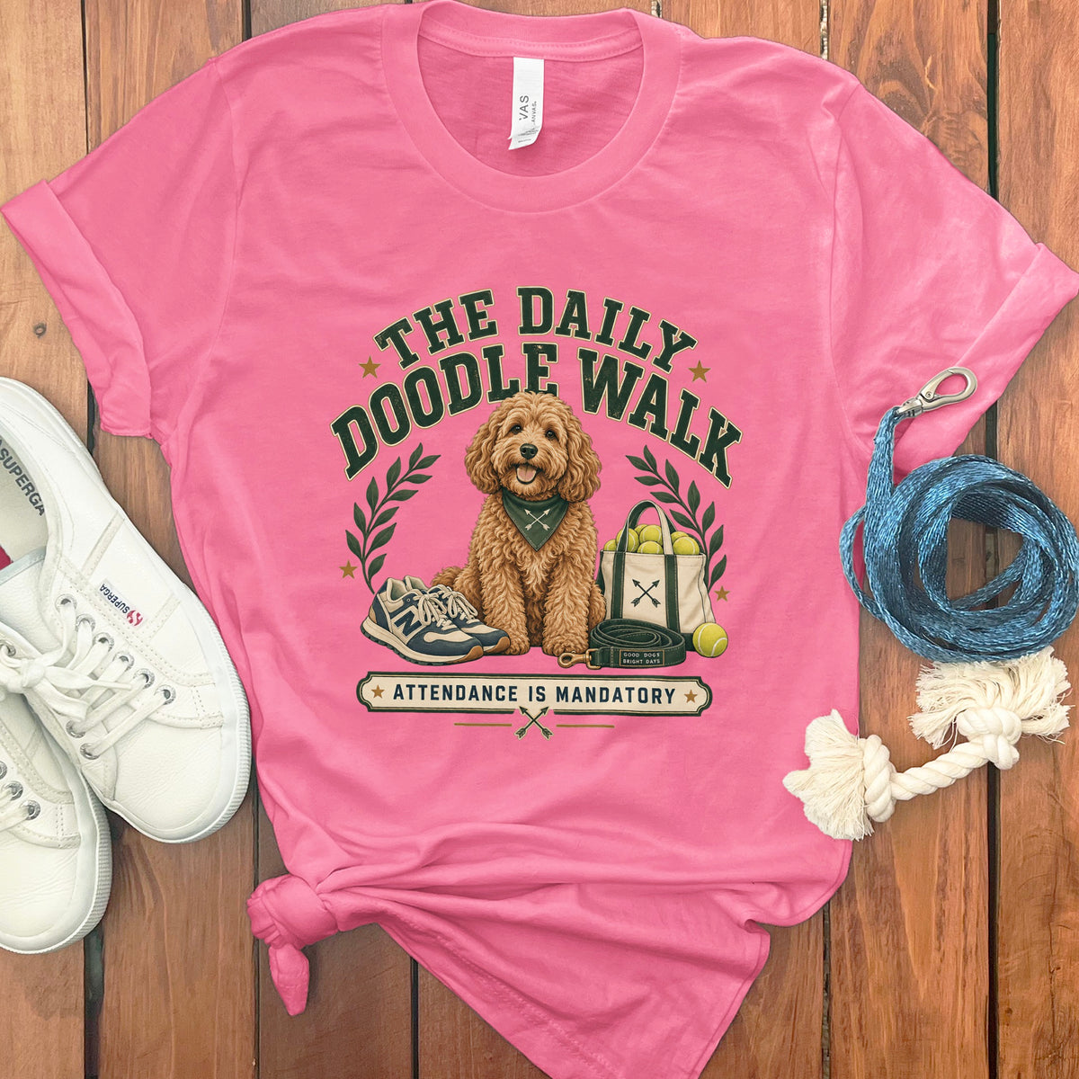 Pink t-shirt with "The Daily Doodle Walk" graphic and a dog.