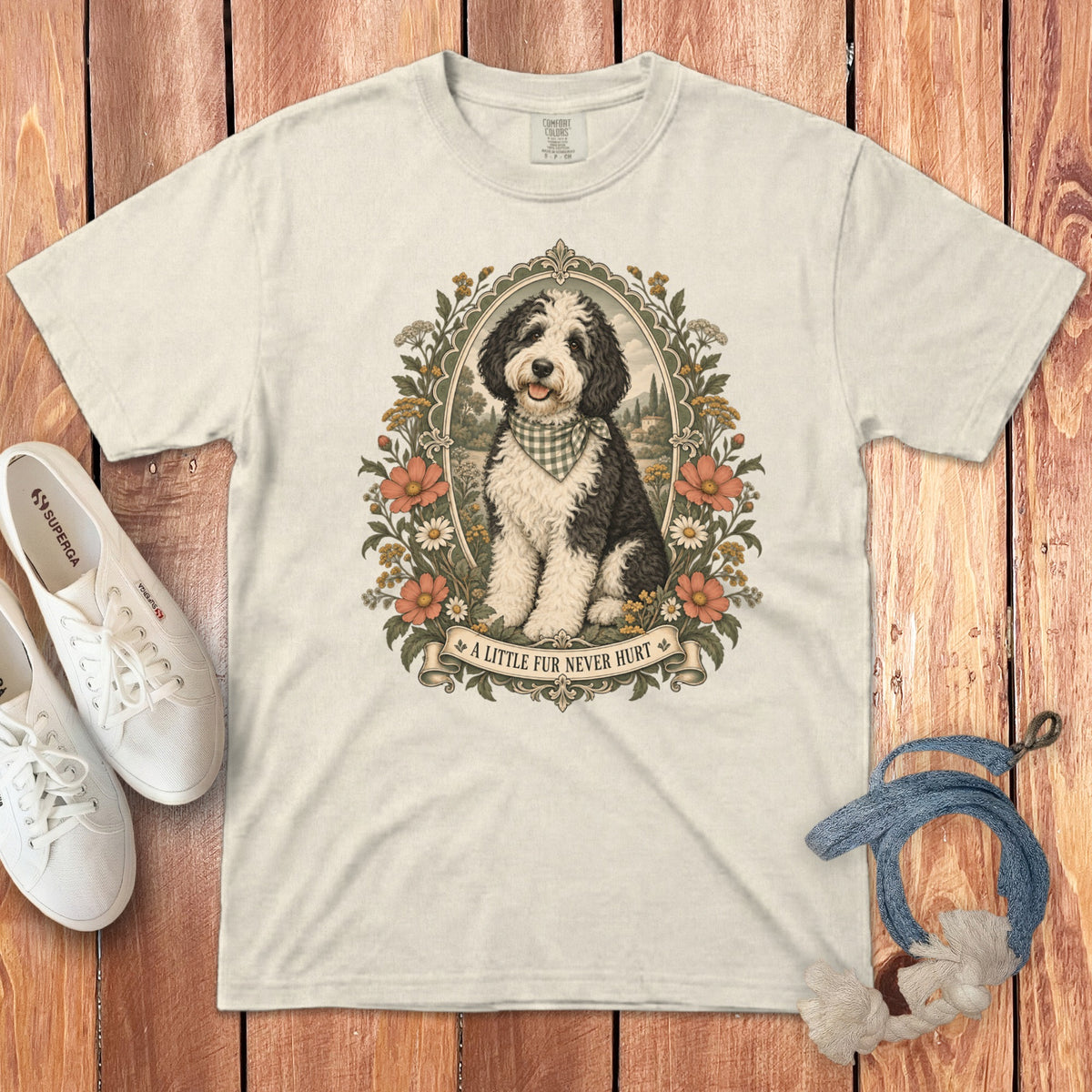 Off-white t-shirt featuring a vintage illustration of a black and white dog surrounded by floral frames and text.