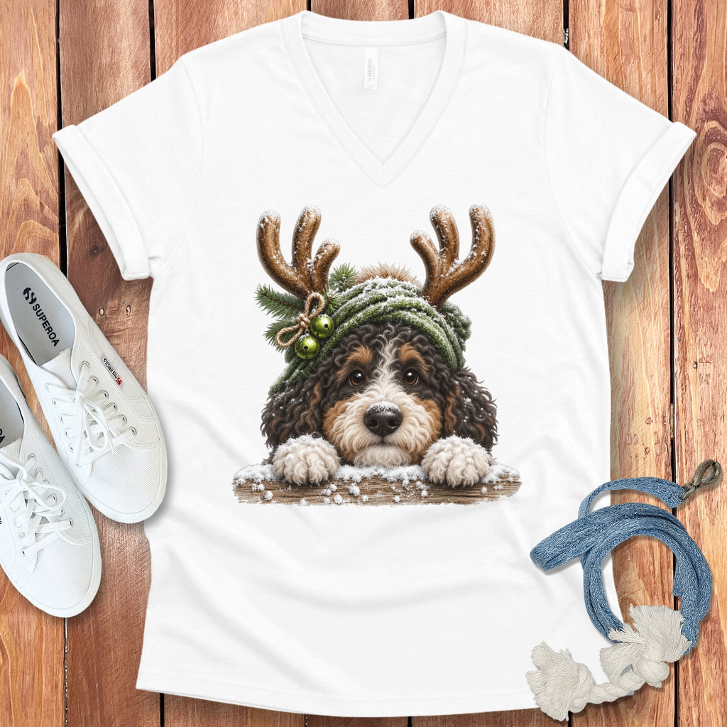 Bernese mountain dog puppy wearing antlers and winter hat on t-shirt.