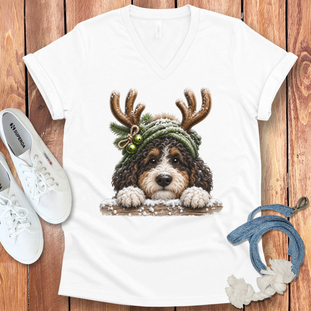 Bernese mountain dog puppy wearing antlers and winter hat on t-shirt.