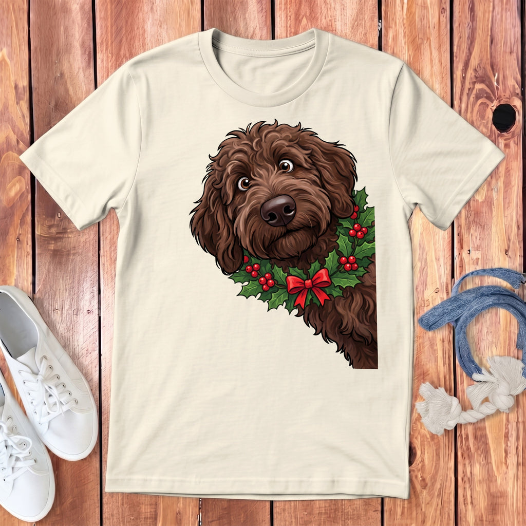 Cream t-shirt featuring a brown doodle dog wearing a holly wreath with a red bow.