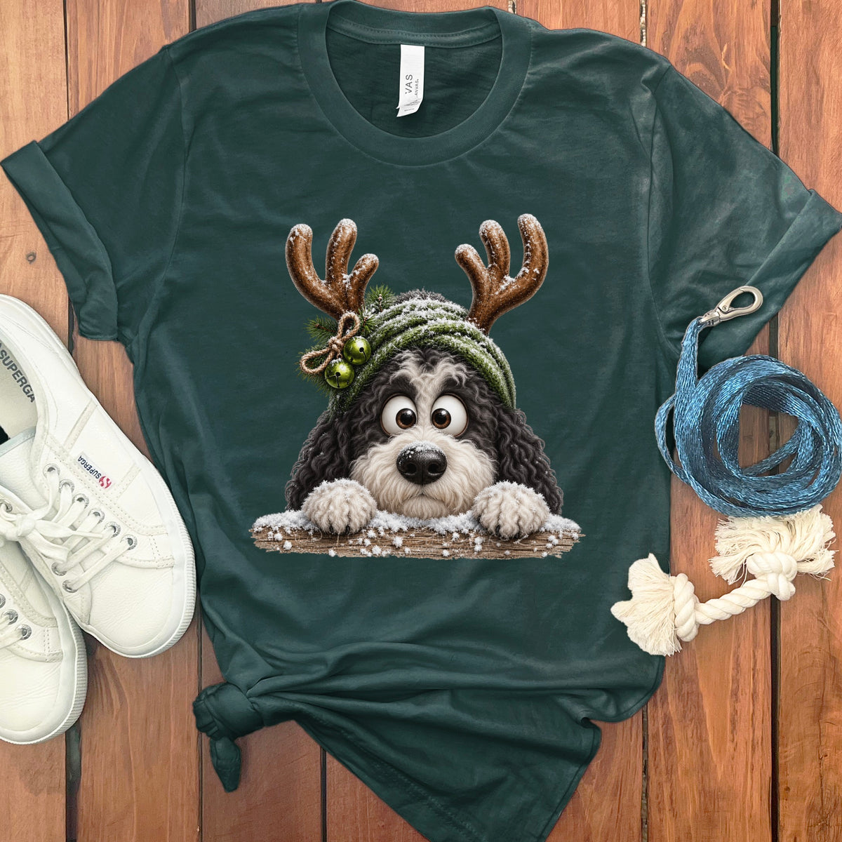 Dark green t-shirt with cartoon dog wearing antlers and green beanie.