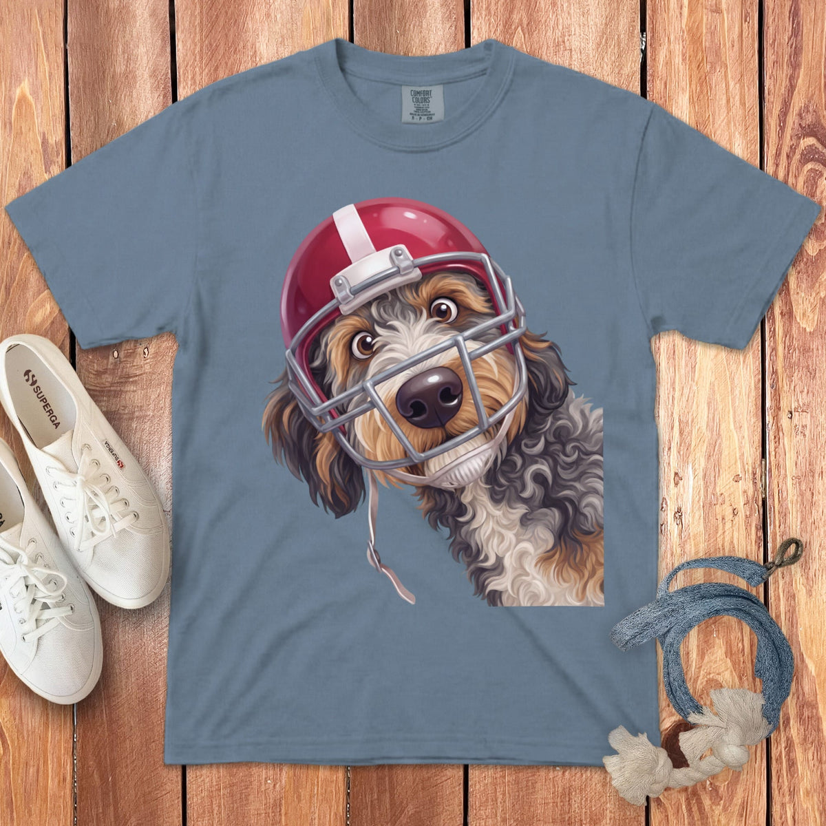 Blue t-shirt with a digital illustration of a dog wearing a red football helmet.