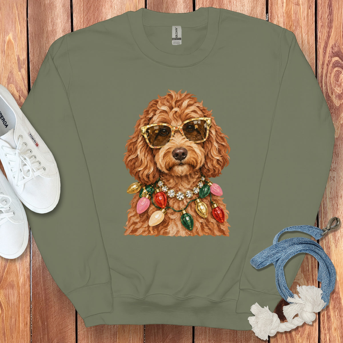 Green crewneck sweatshirt with a doodle wearing sunglasses and a Christmas light necklace.