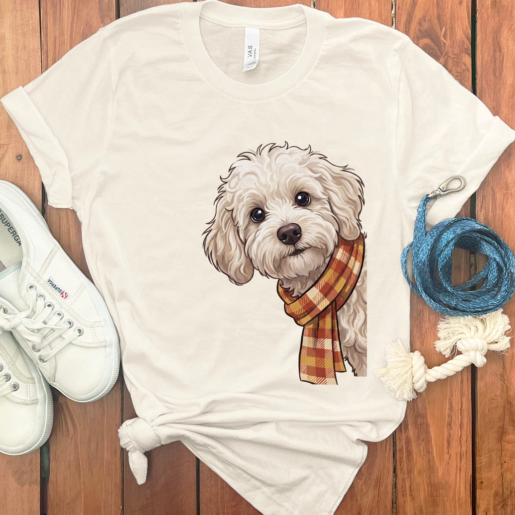 Cream t-shirt with illustration of a fluffy white dog wearing a plaid scarf