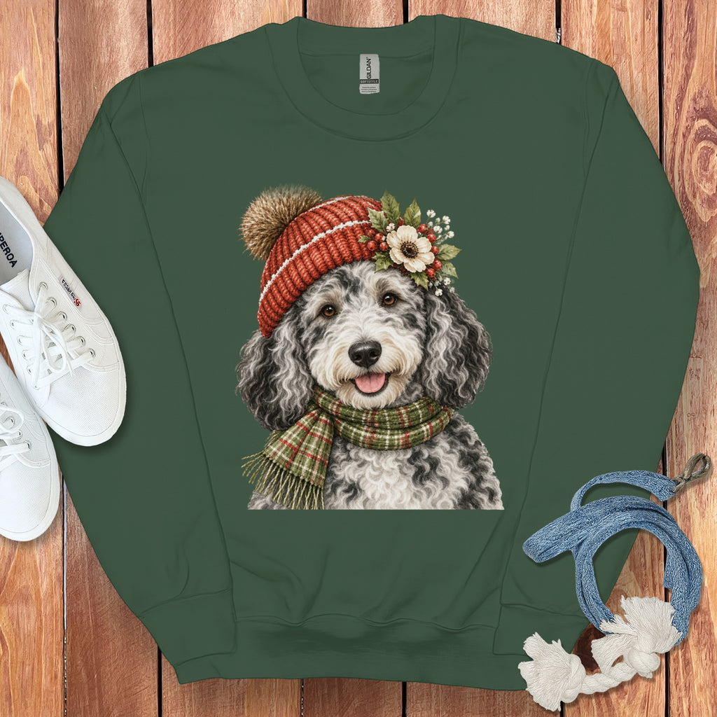 Green sweatshirt with illustration of a dog wearing a hat and scarf.