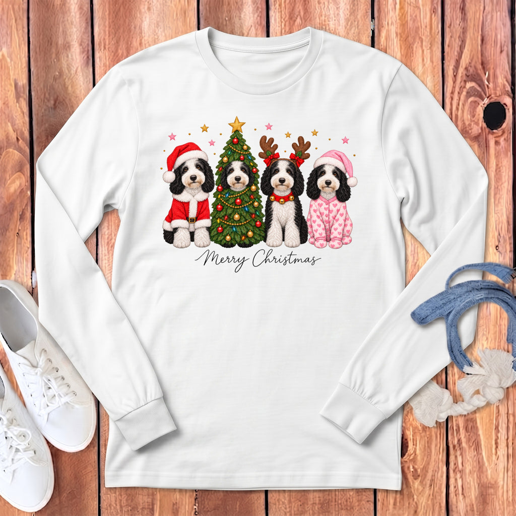 White long-sleeve t-shirt featuring a Christmas graphic of four dogs, a decorated tree, and text.