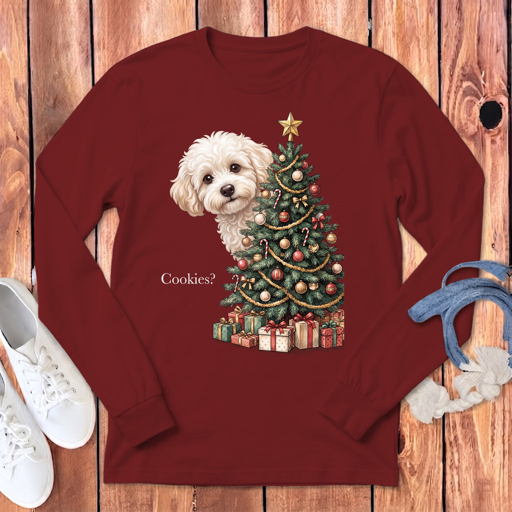 White dog peeking behind a decorated Christmas tree with presents and the text "Cookies?".