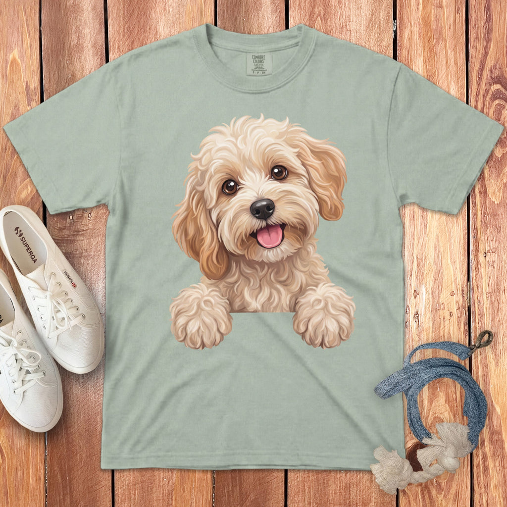 Light green t-shirt with a watercolor illustration of a fluffy dog's face.