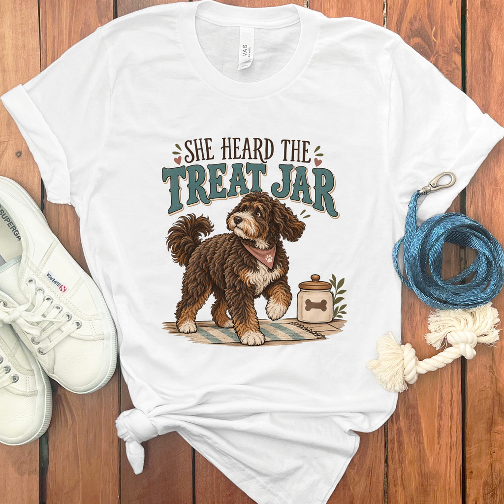 White t-shirt with graphic of a brown dog and text "She Heard the Treat Jar".