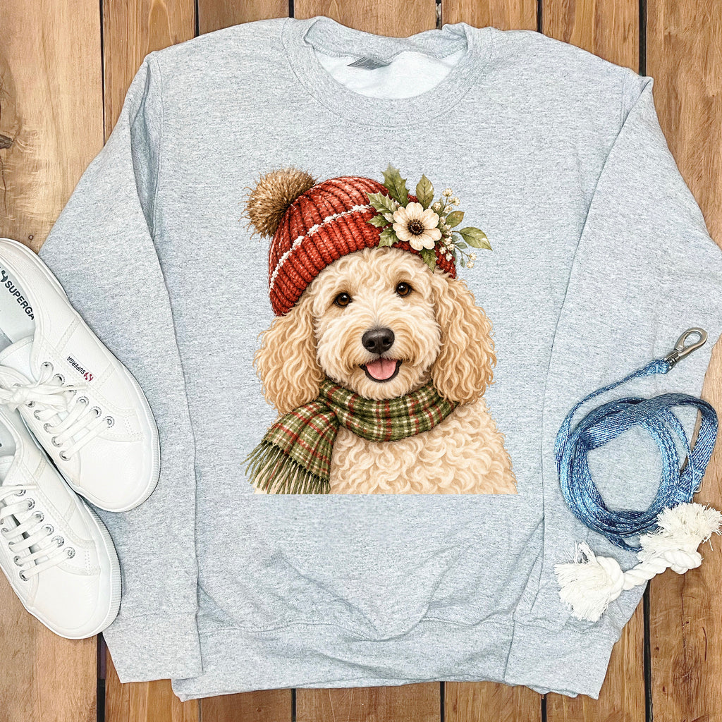 Grey sweatshirt with a watercolor dog wearing a red beanie and plaid scarf.