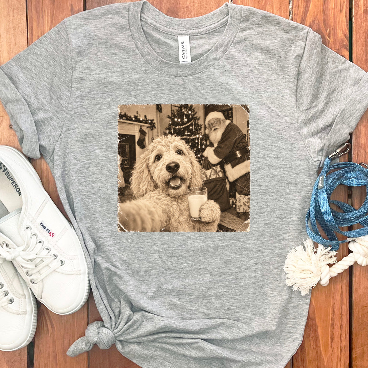 Heather gray t-shirt featuring a sepia-toned graphic of a fluffy dog taking a selfie with Santa.