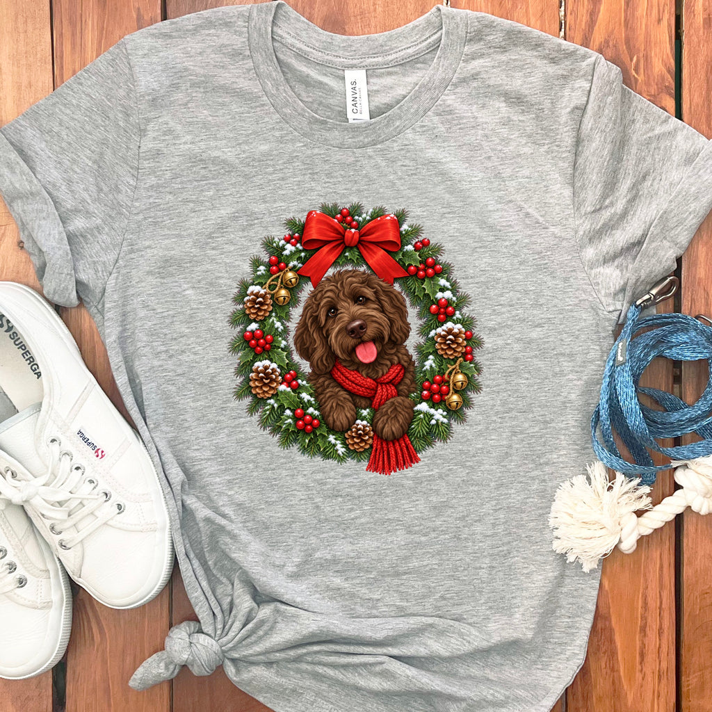 Heather gray crewneck t-shirt featuring an illustration of a brown doodle dog inside a Christmas wreath.