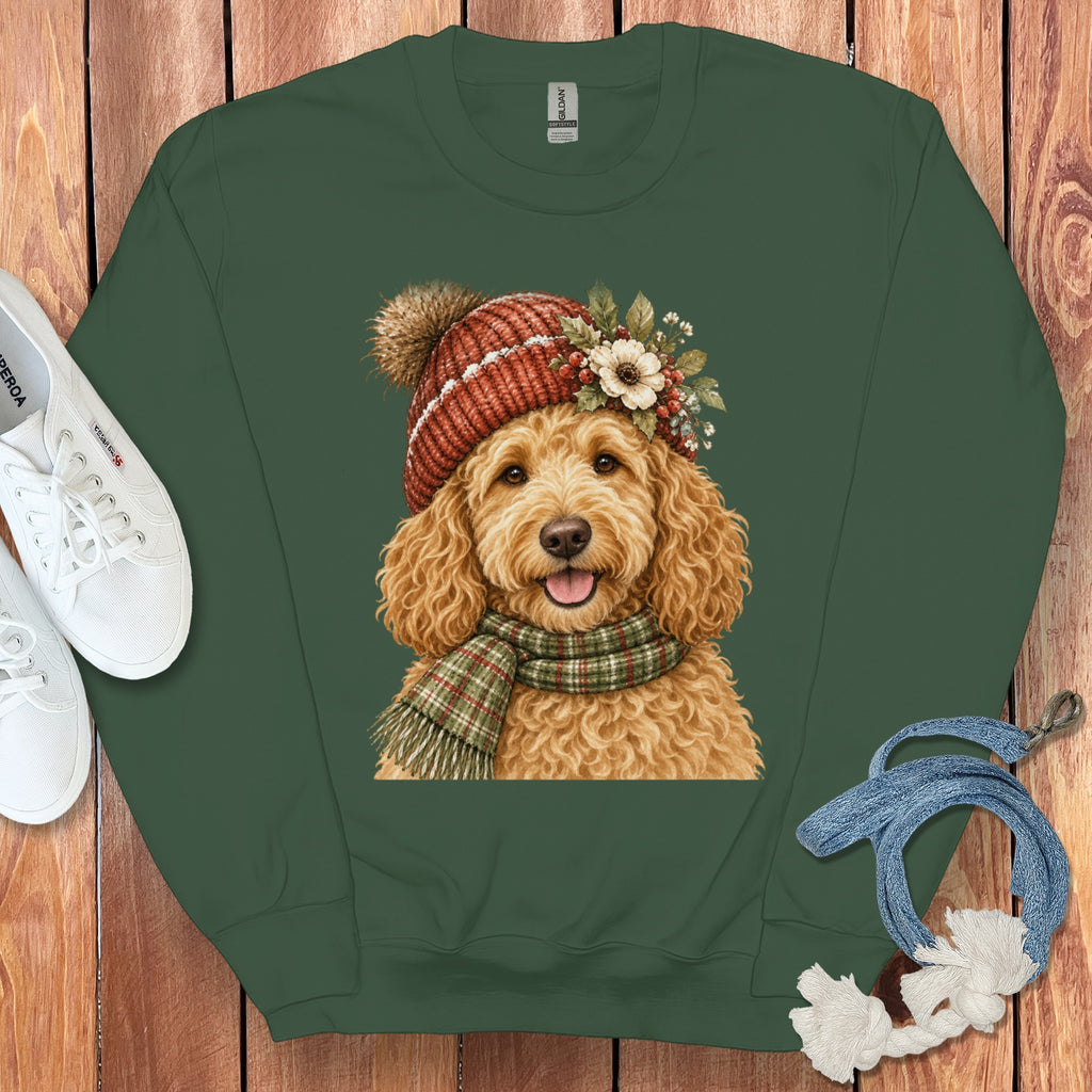 Green sweatshirt with a festive Goldendoodle illustration wearing a knit hat and scarf.