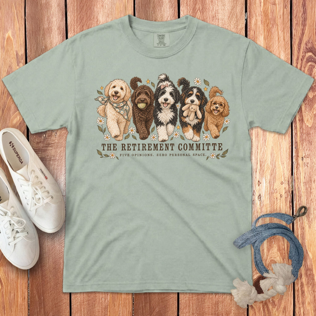 Sage green crewneck t-shirt featuring an illustration of five dogs and text that reads The Retirement Committee.
