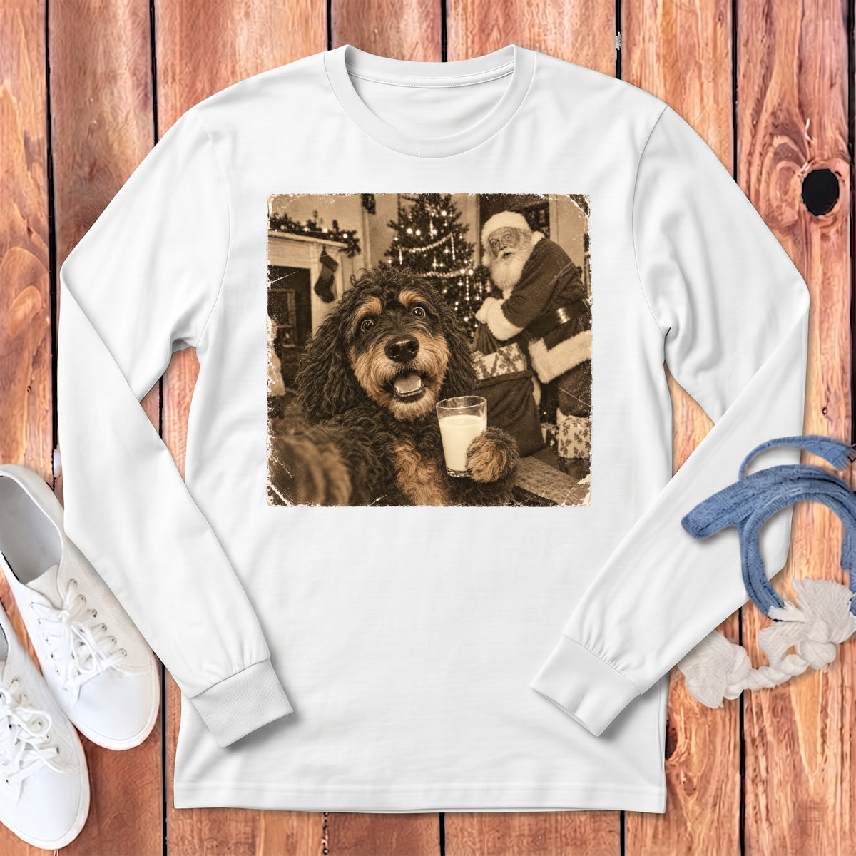 A white long-sleeved t-shirt features a vintage graphic of a dog holding a glass of milk with Santa Claus in the background.