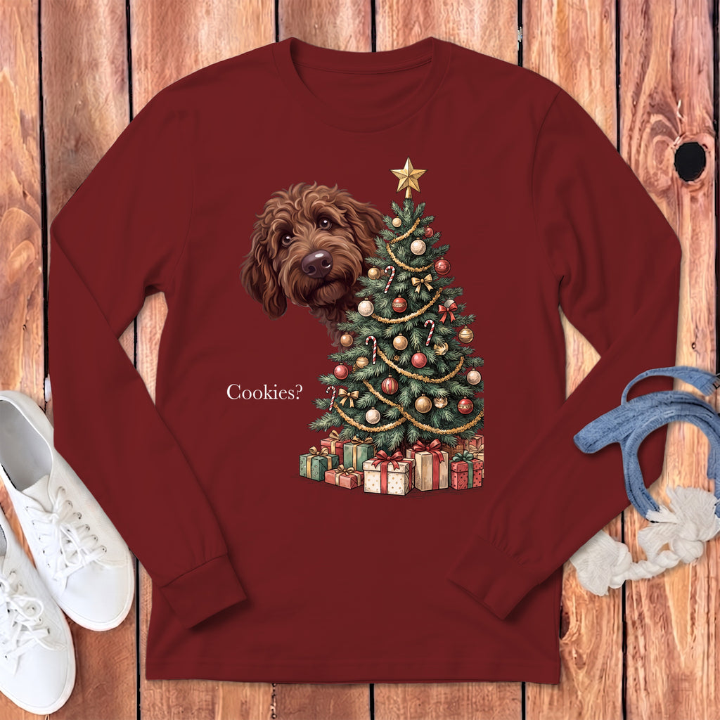Maroon long-sleeve shirt with a doodle dog peeking over a Christmas tree and the text "Cookies?".