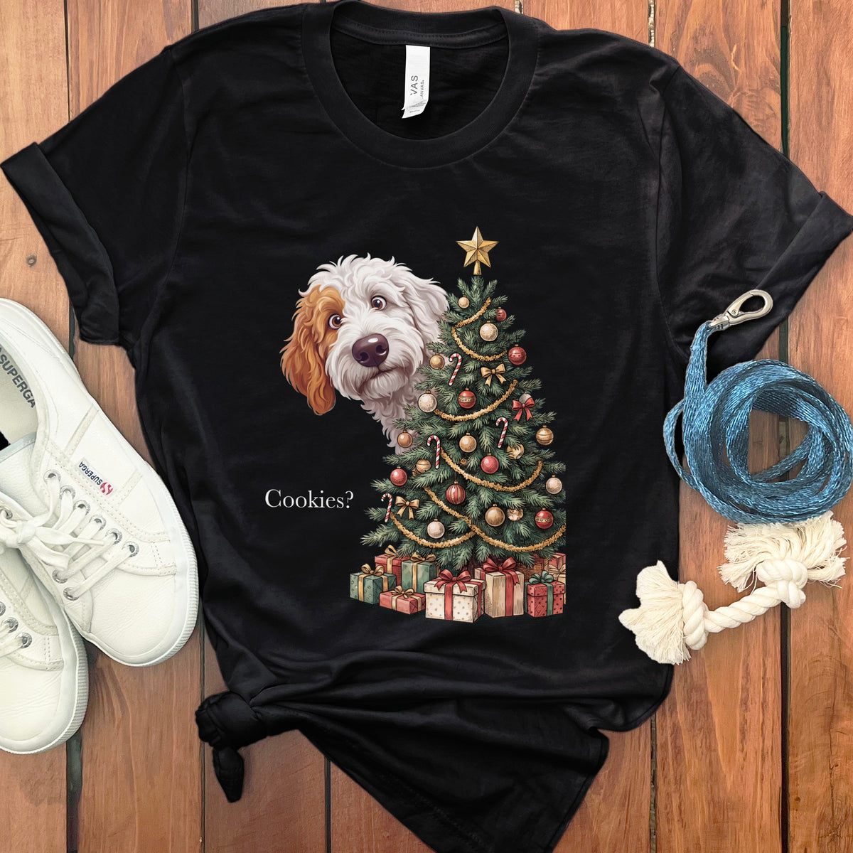 Black t-shirt featuring a dog peeking from behind a Christmas tree and the text "Cookies?".