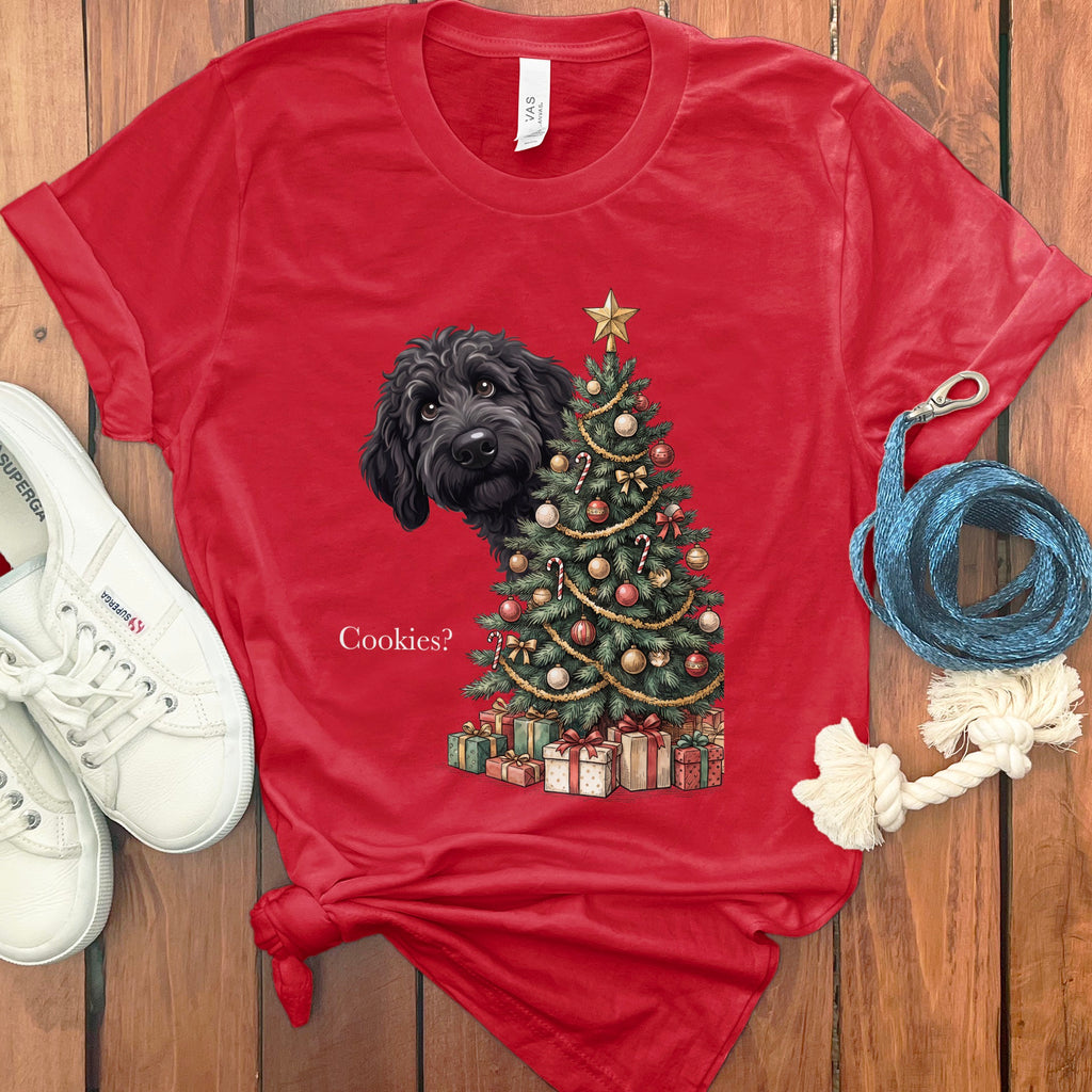 Red t-shirt with a black dog peeking behind a Christmas tree and the text "Cookies?".
