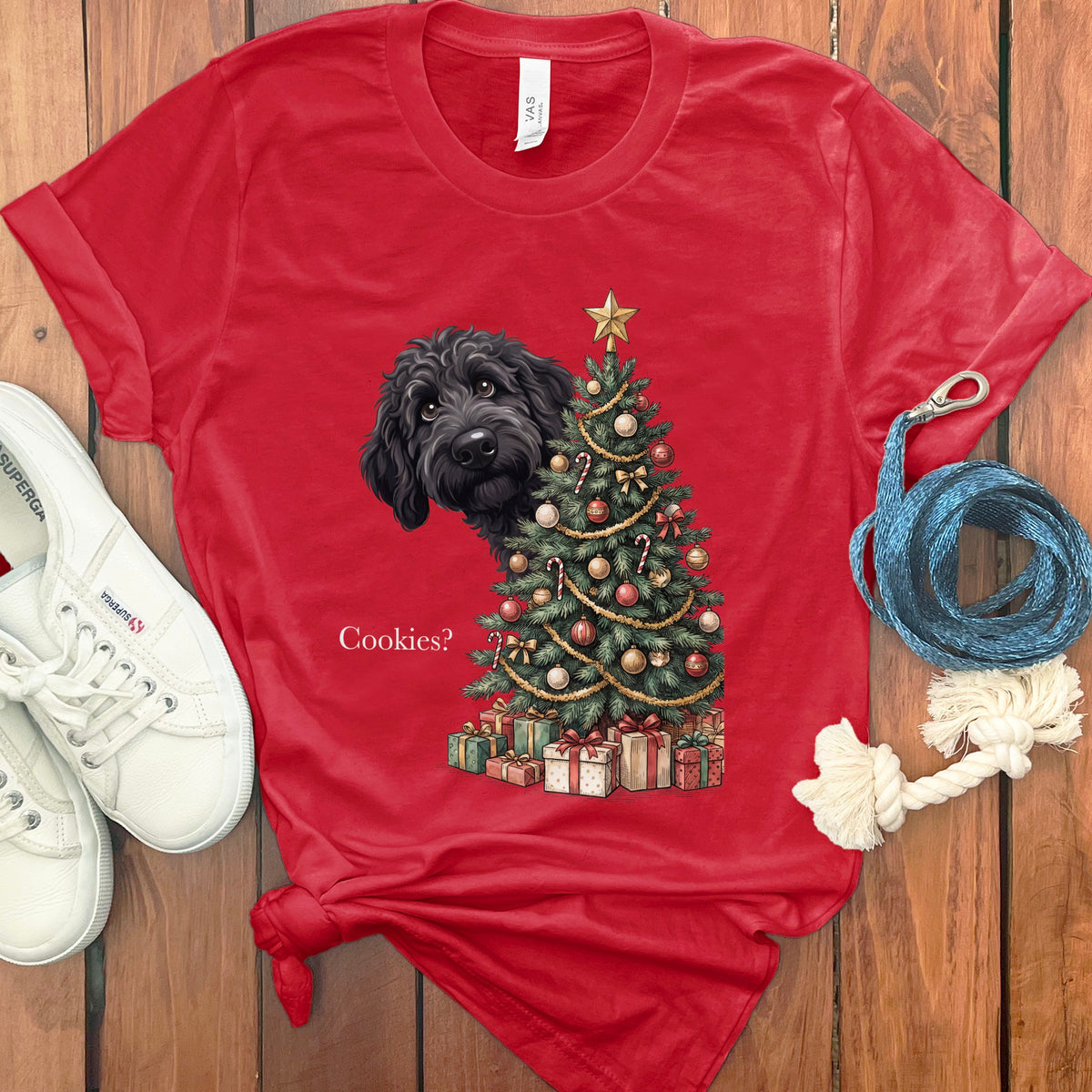 Red t-shirt with a black dog peeking behind a Christmas tree and the text "Cookies?".